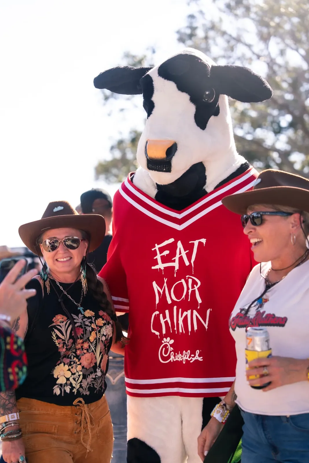 Chick-fil-A cow mascot with fans, a festival sponsorship brand experience