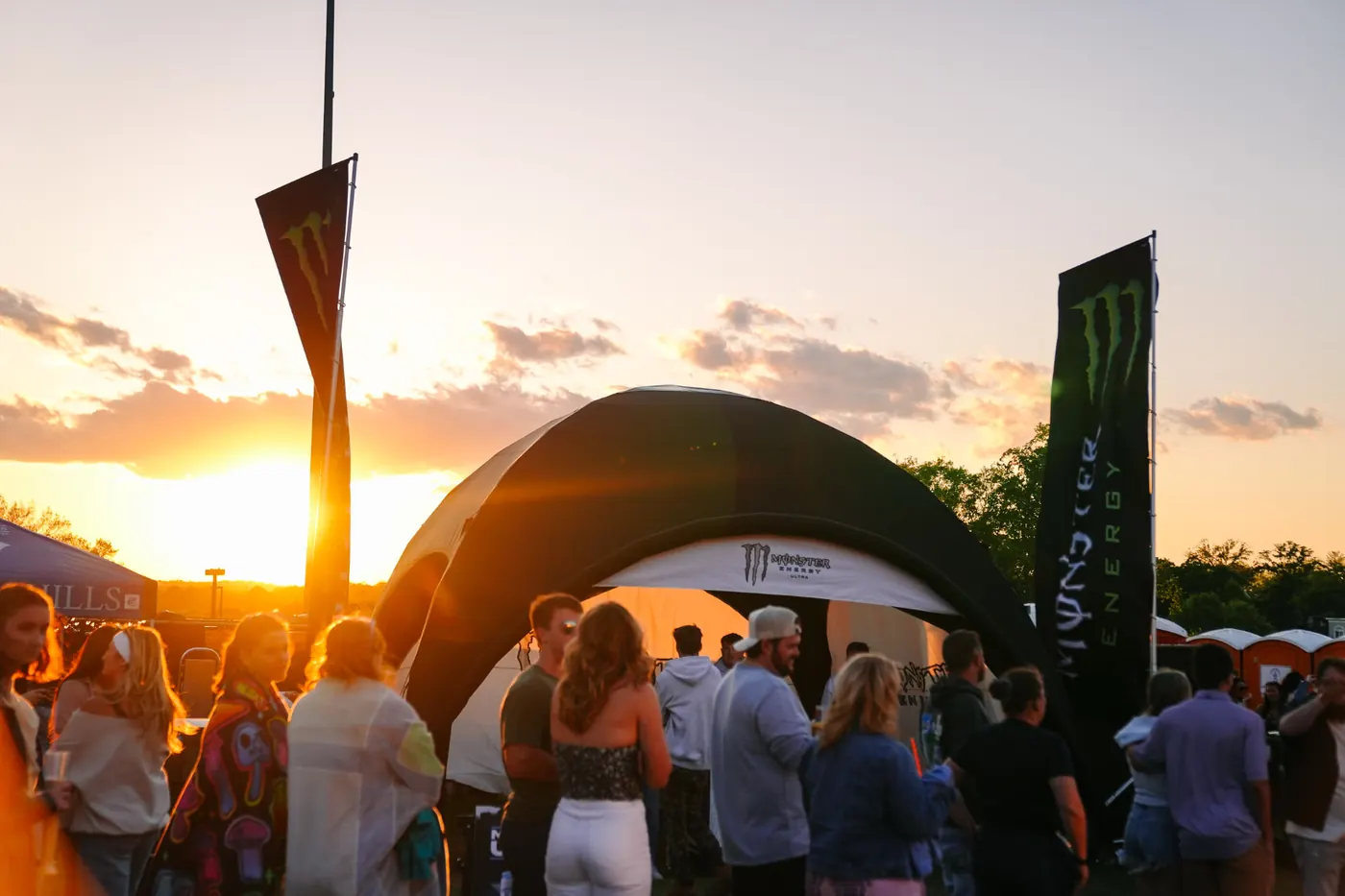 Fans at a branded Monster Energy tent, a festival sponsorship brand experience