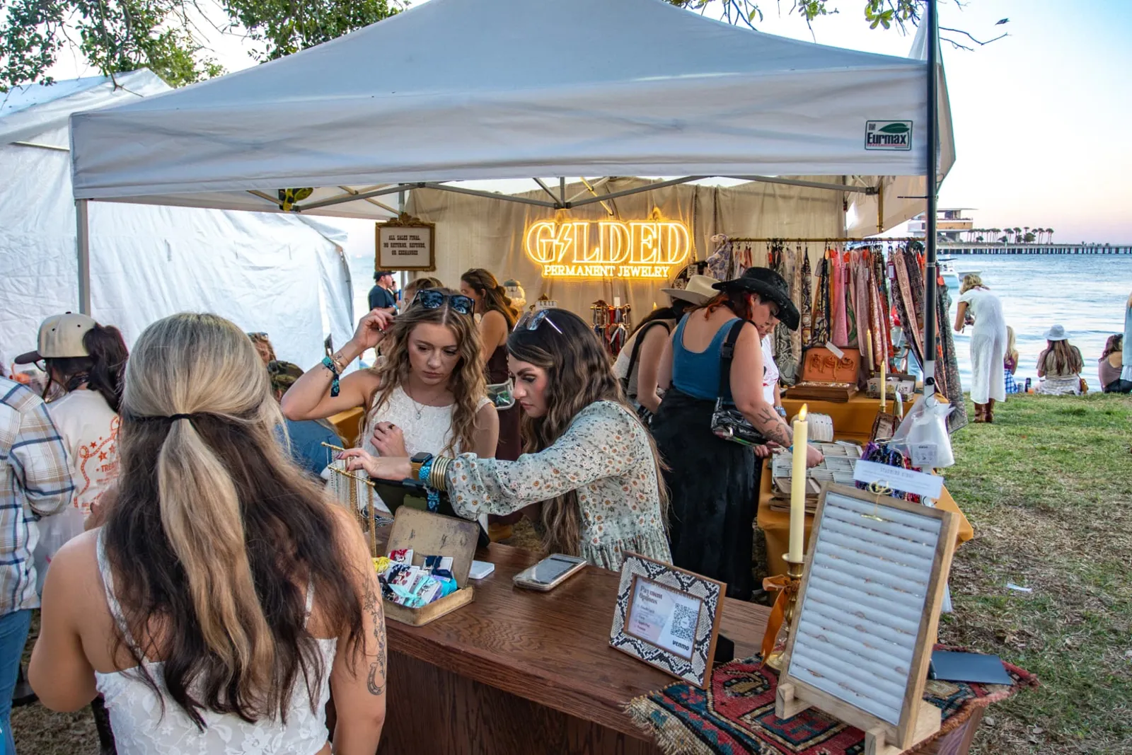 Fans shopping a vendor booth, a festival brand experience
